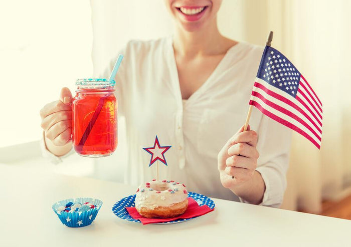 women celebrating America with a donut and drink