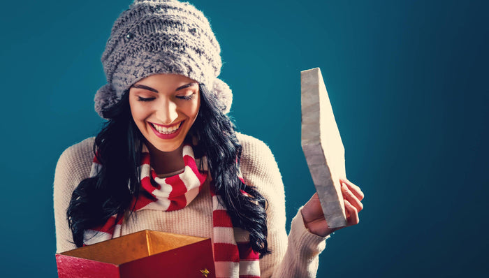 woman smiling opening gift